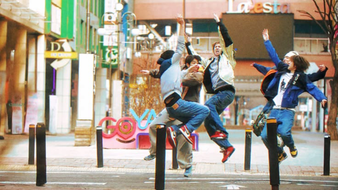 CORTIS members jumping in a city street